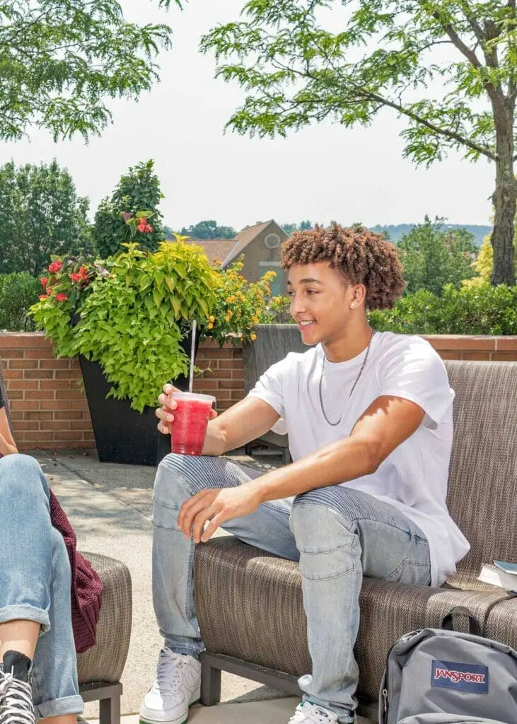 Student having a beverage outside
